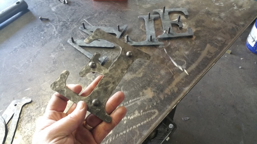 welding the rivets to the letters
